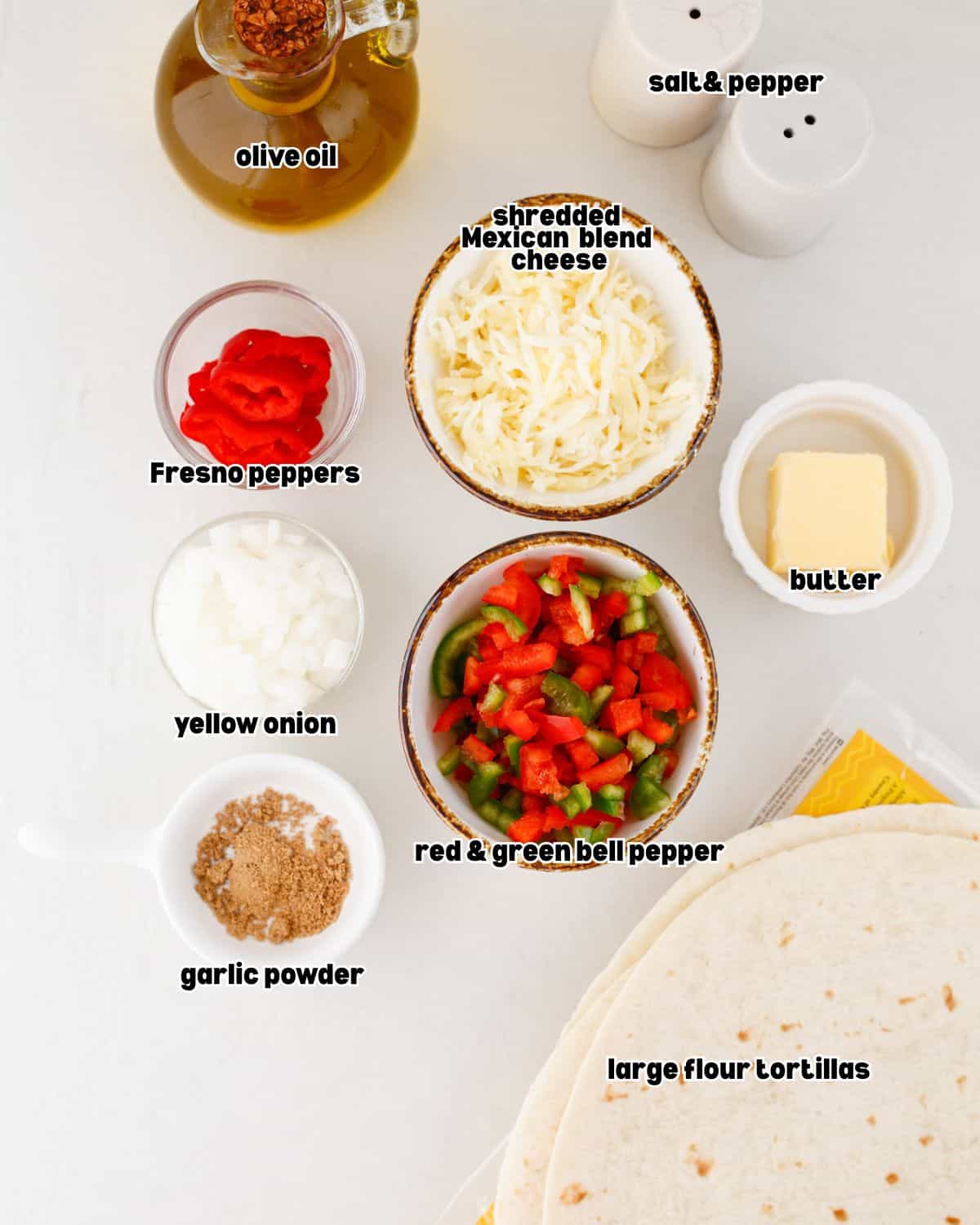 ingredients for steak fajita quesadillas arranged in bowls on a kitchen countertop.