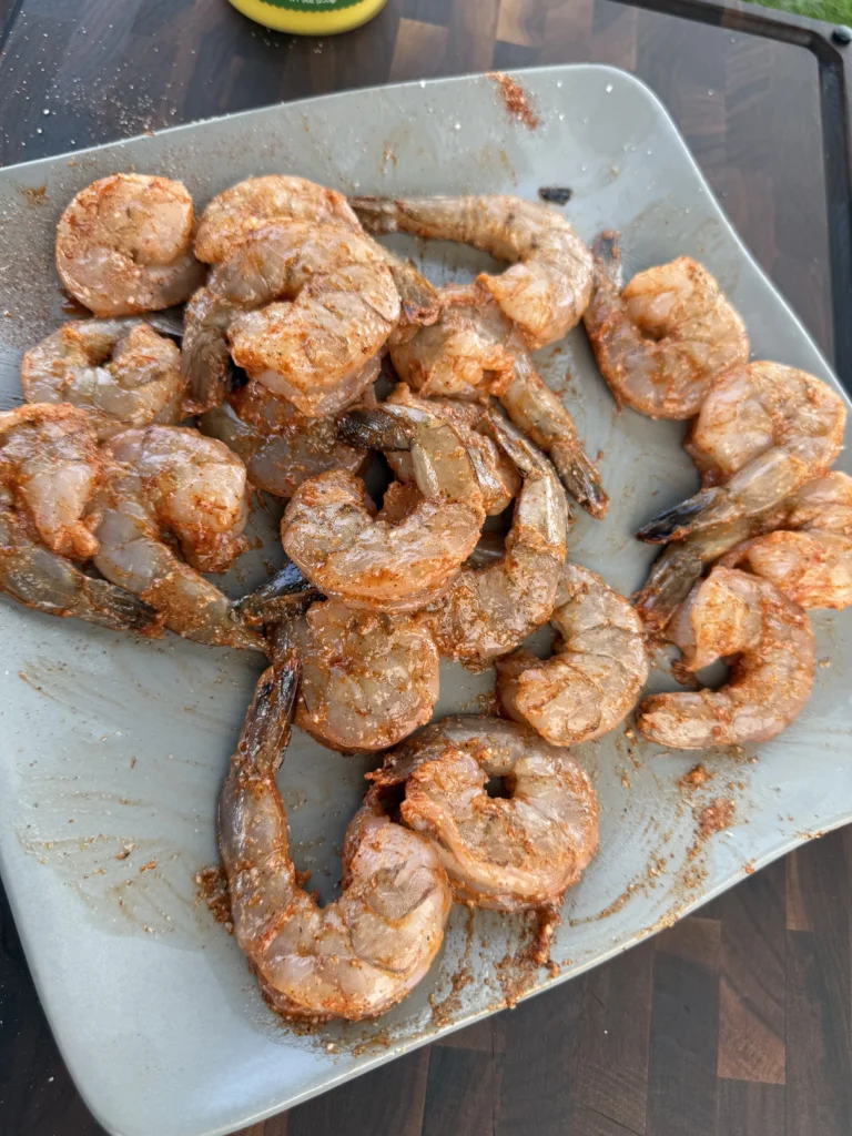 Raw shrimp seasoned and ready to grill