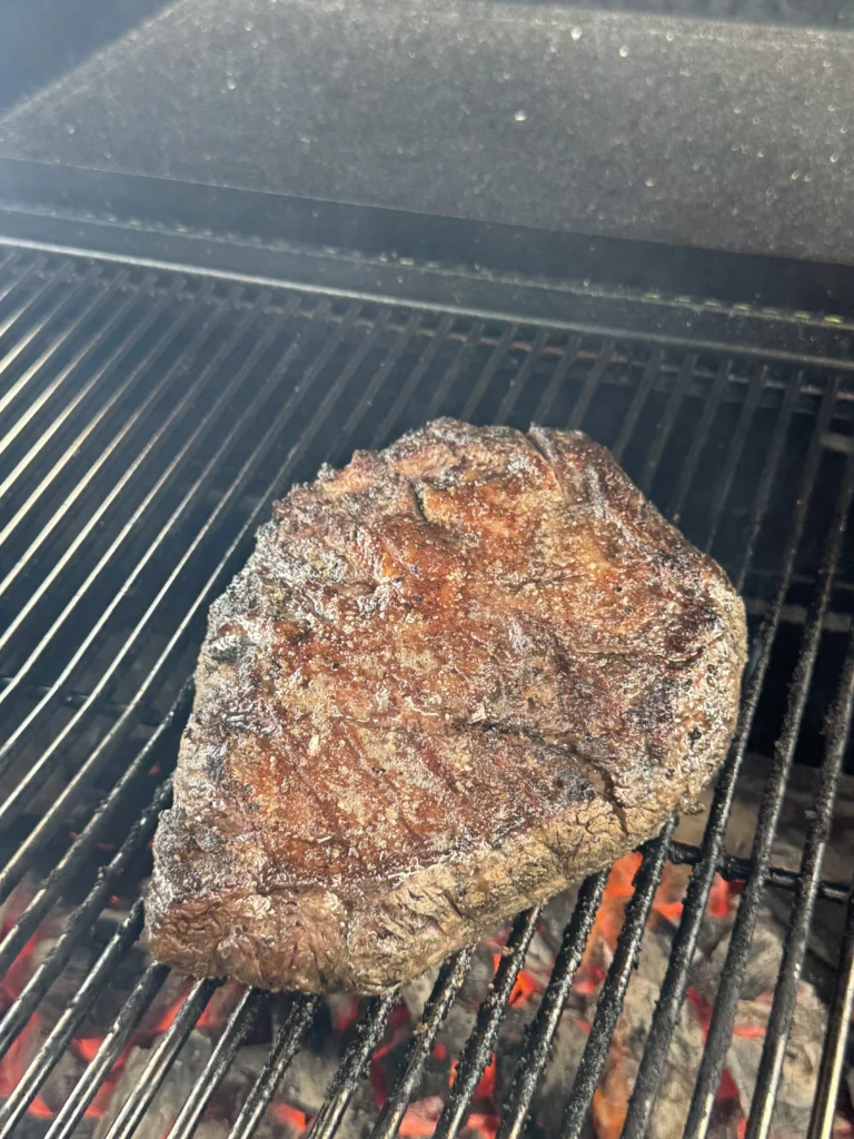 Perfectly seared Picanha steak over open flame