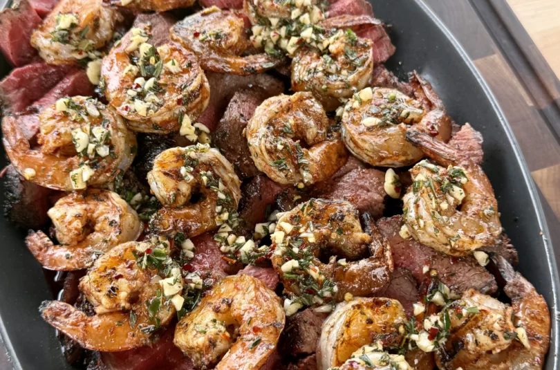Steak and shrimp plated side-by-side