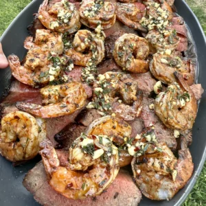 Surf and turf plated with garlic butter on top