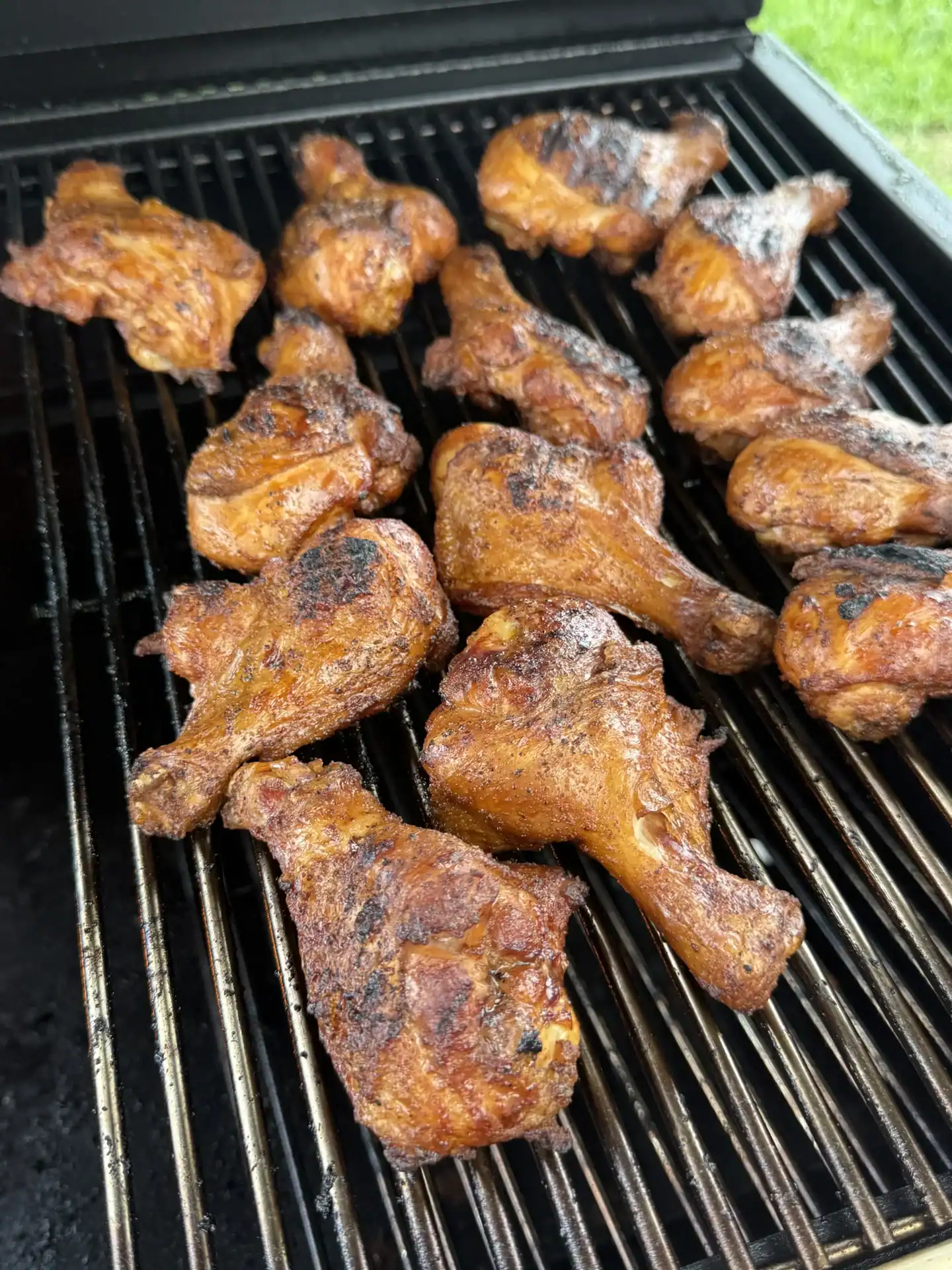 Seared butterflied chicken drumsticks finishing over indirect heat