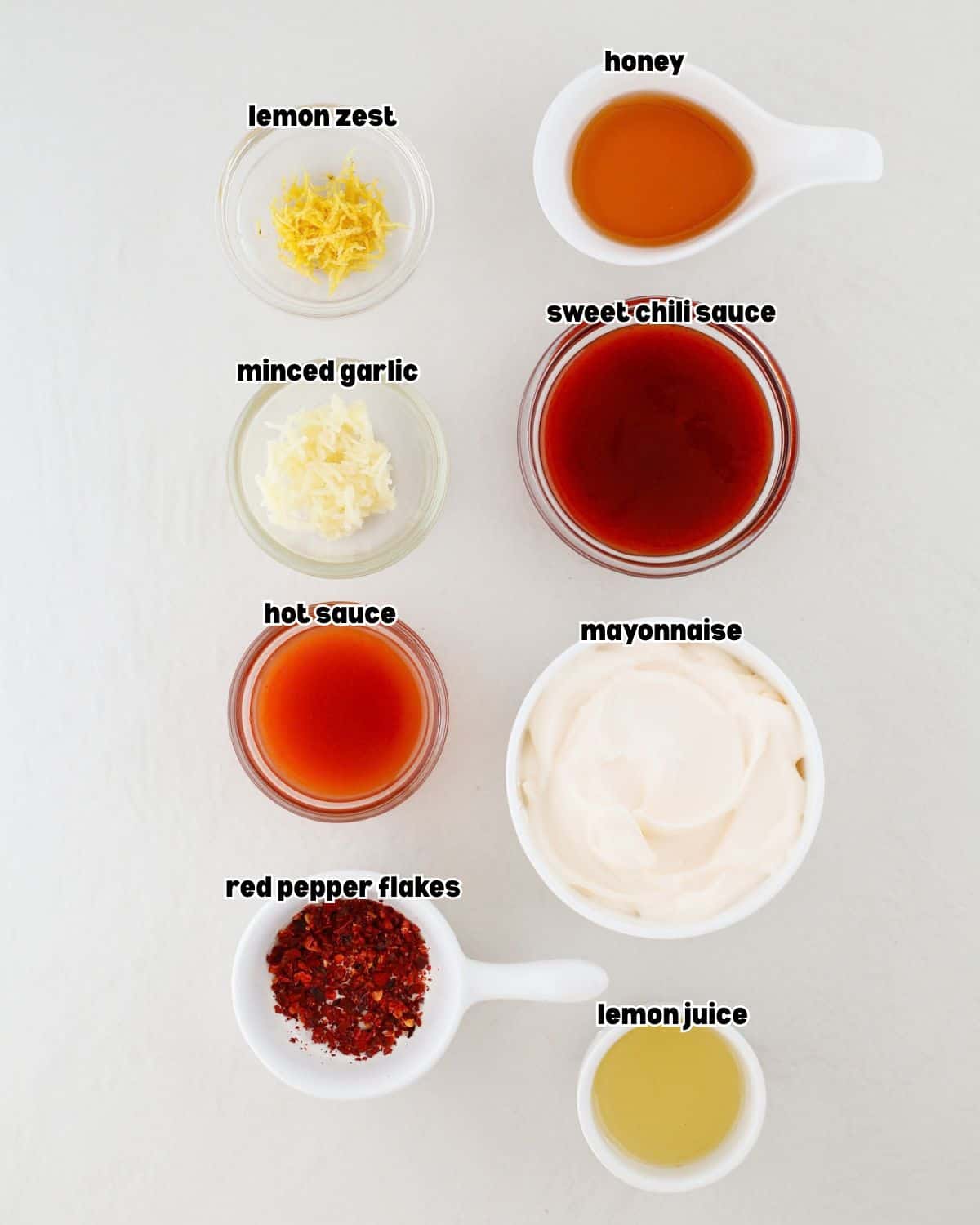 bowls of ingredients used to make bang bang sauce placed on a kitchen countertop.