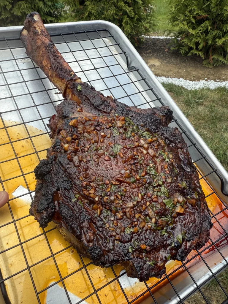 Complete tomahawk ribeye with dramatic bone presentation and golden seared exterior