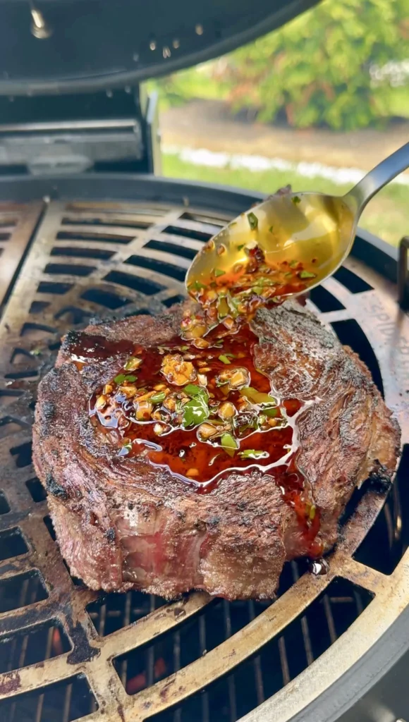 Tomahawk steak plated with garlic butter sauce