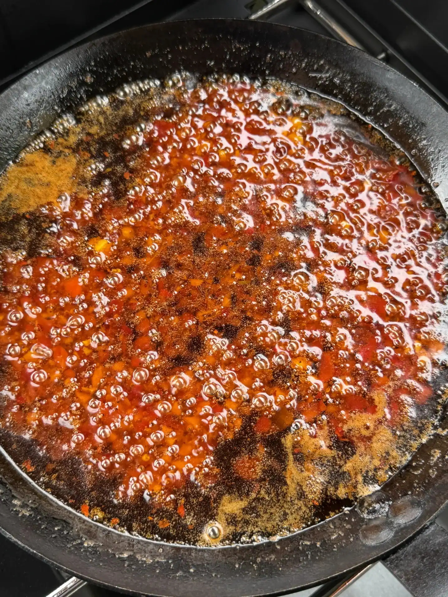 saucepan with a honey based chicken wing sauce and finely chopped red chilies.