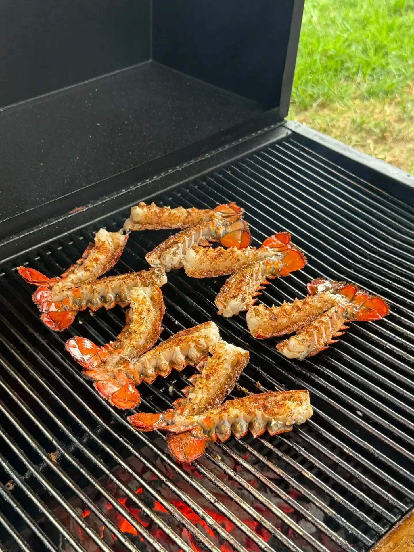 cooking the lobster tails on the hasty bake for surf n turf