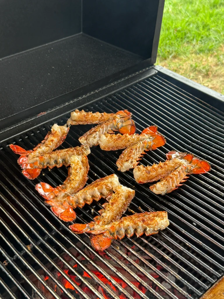 cooking the lobster tails on the hasty bake for surf n turf