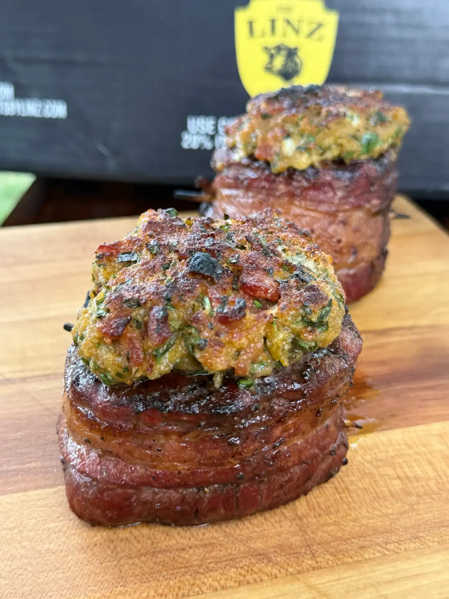bacon wrapped filets on the cutting board