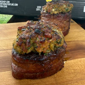 bacon wrapped filets on a cutting board with linz meats