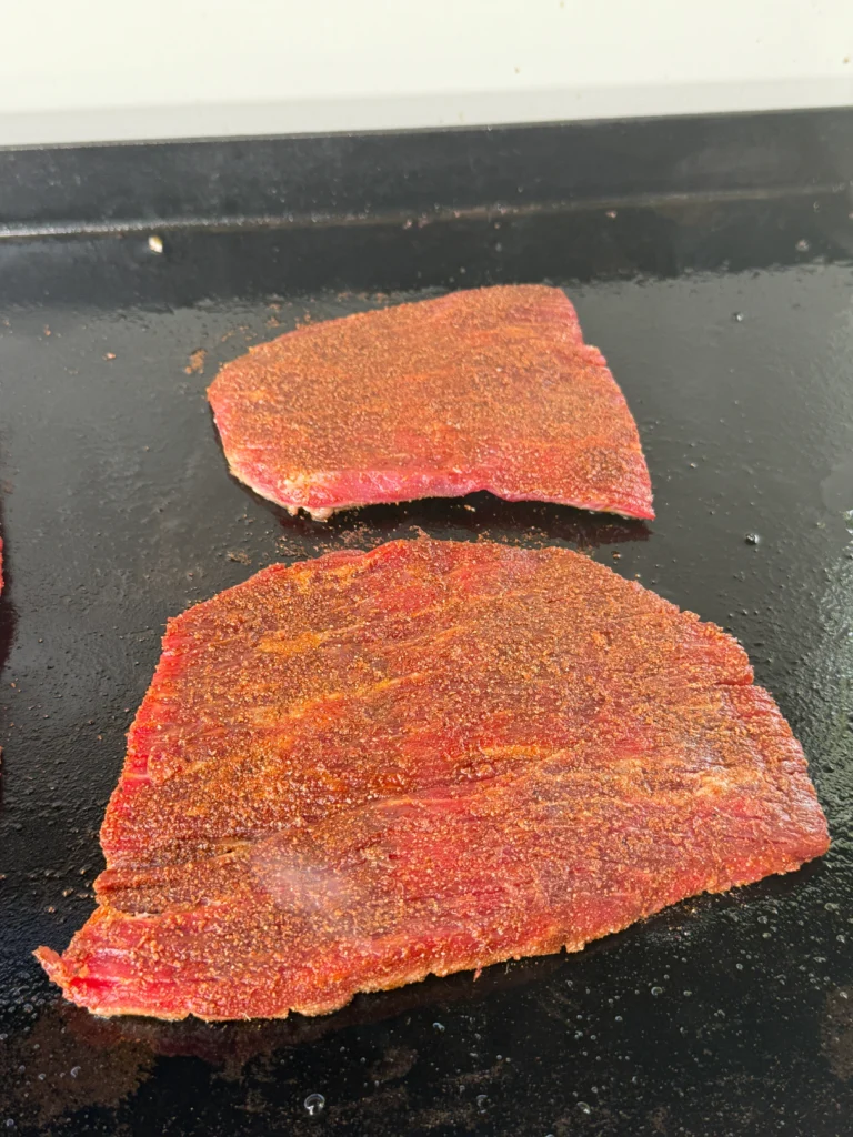 cooked skirt steak on the griddle top