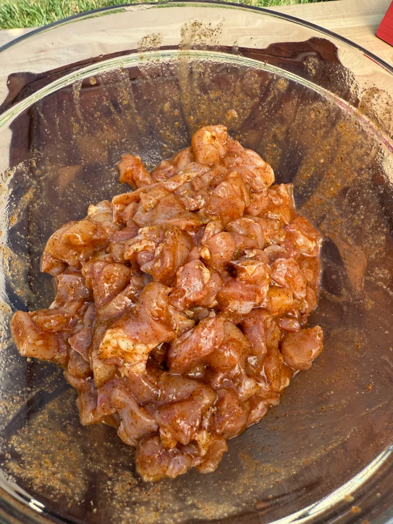 chicken in a bowl with seasoning