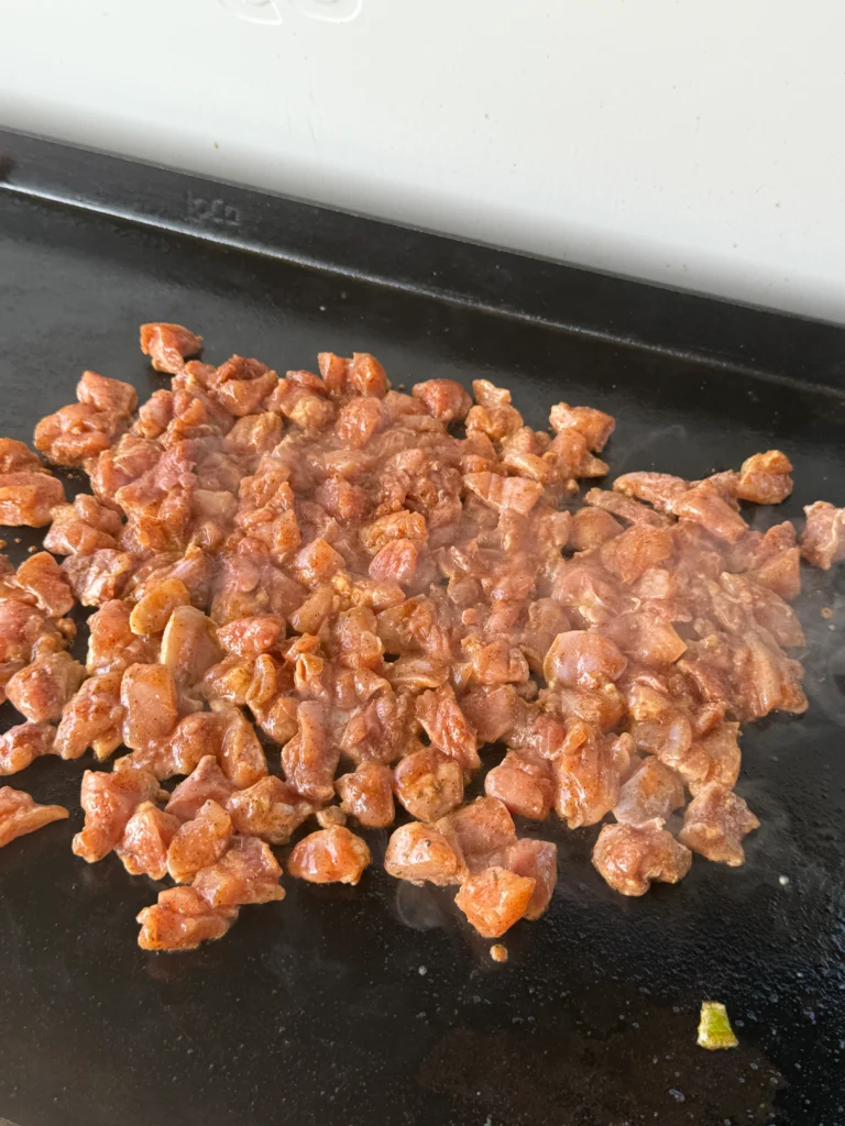 cooking the chicken thighs on the griddle