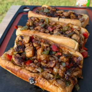 3 chicken cheesesteaks on a cutting board