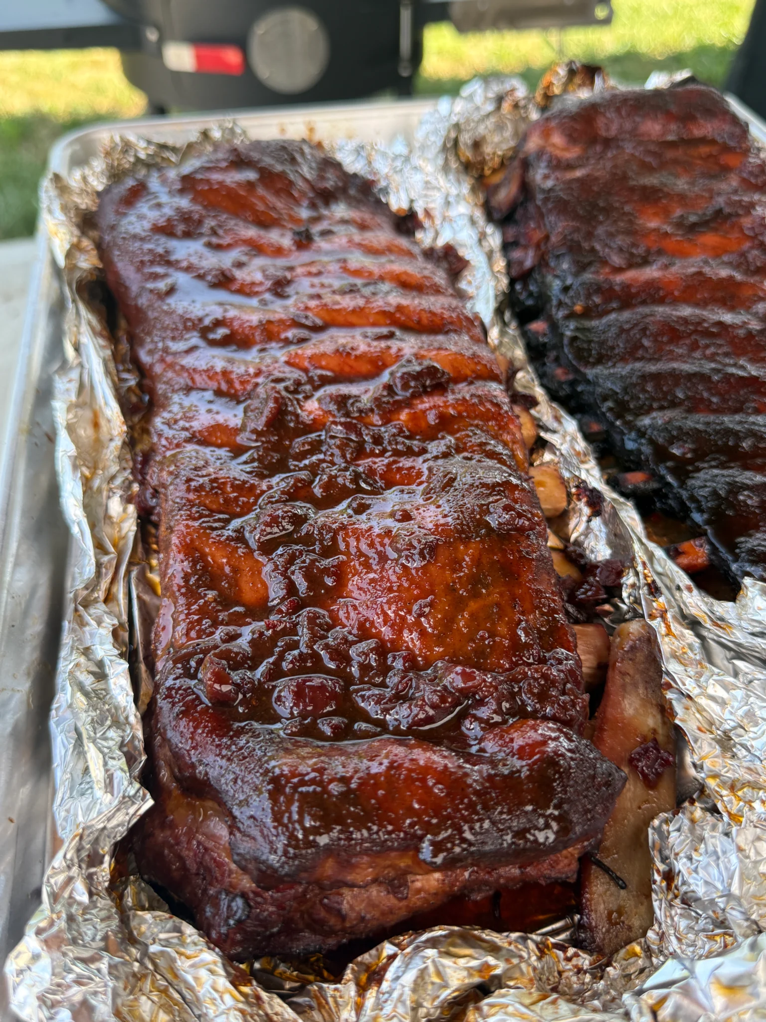 Carefully opening foil packet to reveal tender steamed ribs with accumulated Cherry Dr Pepper juices