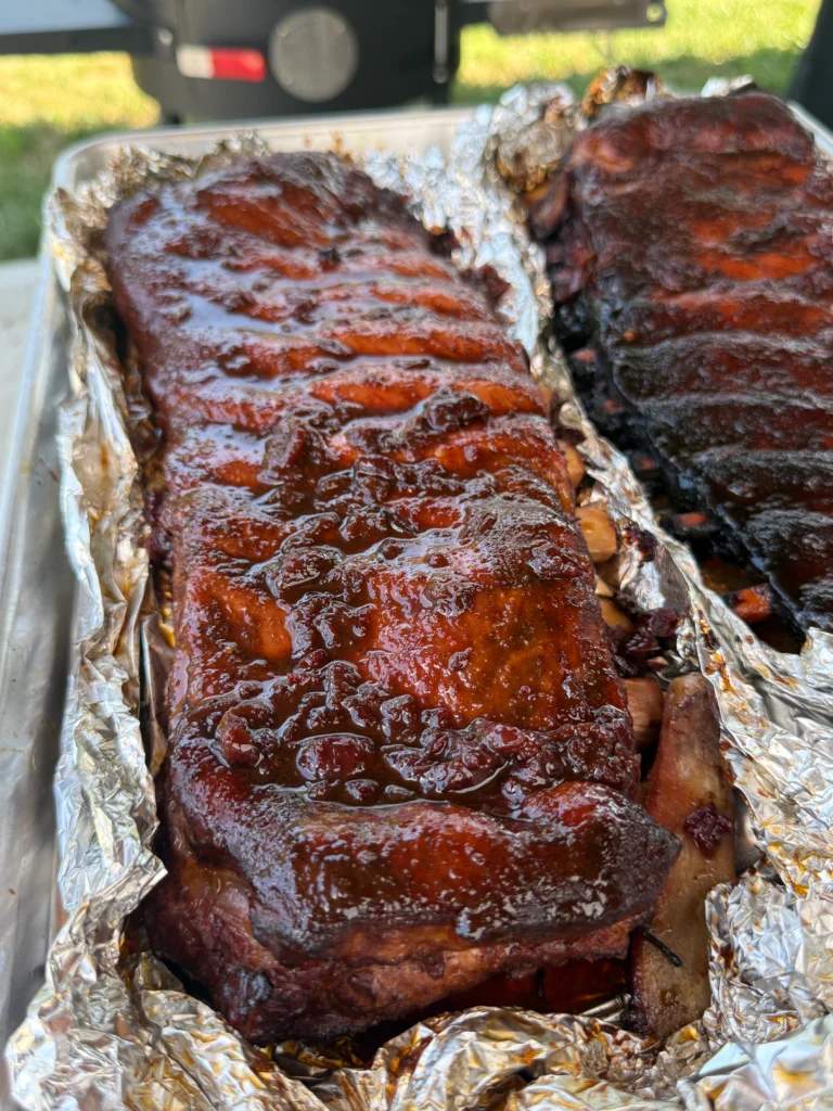 Carefully opening foil packet to reveal tender steamed ribs with accumulated Cherry Dr Pepper juices