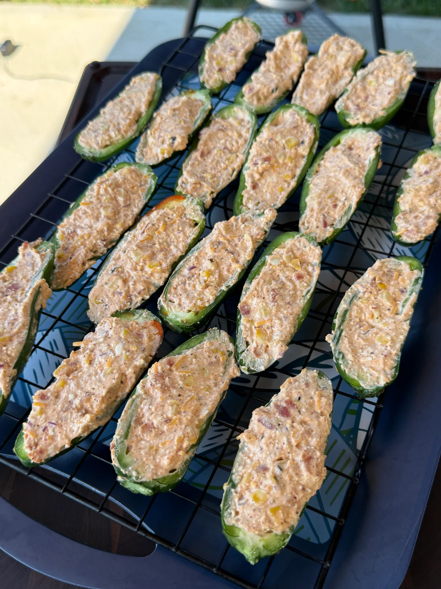filled jalapeno poppers on a baking tray