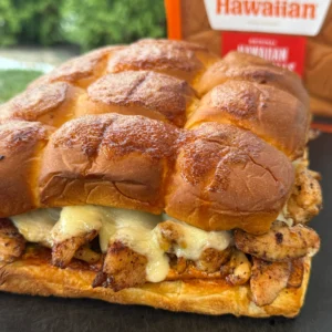 grilled nashville hot chicken sliders on a cutting board