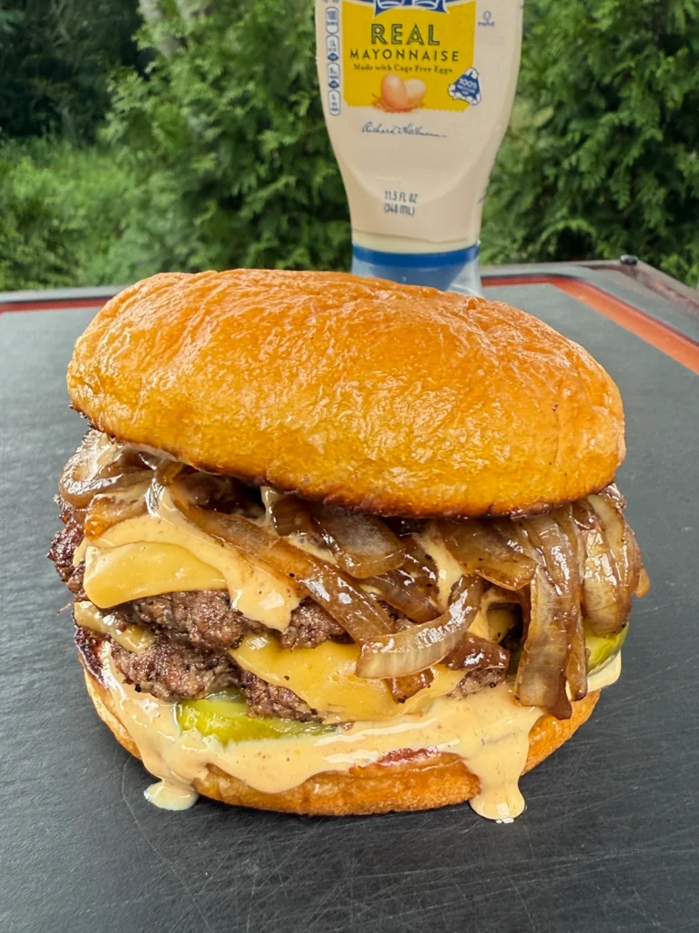 perfectly grilled smash burger on a cutting board