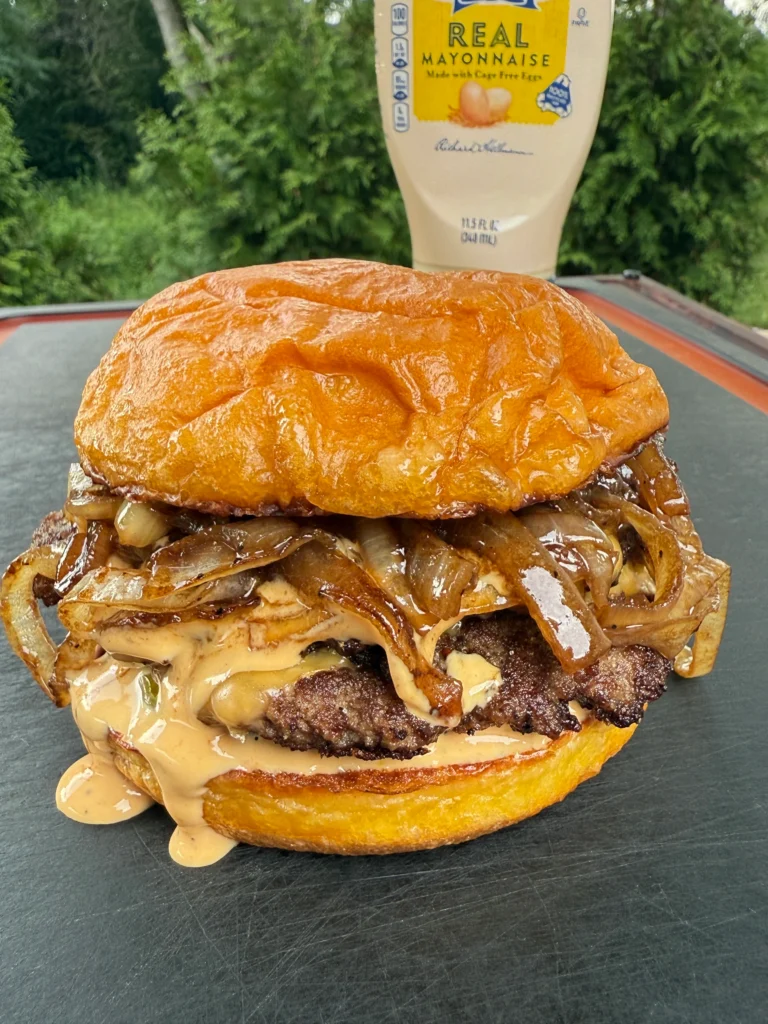 griddled smash burger with mayo on the background