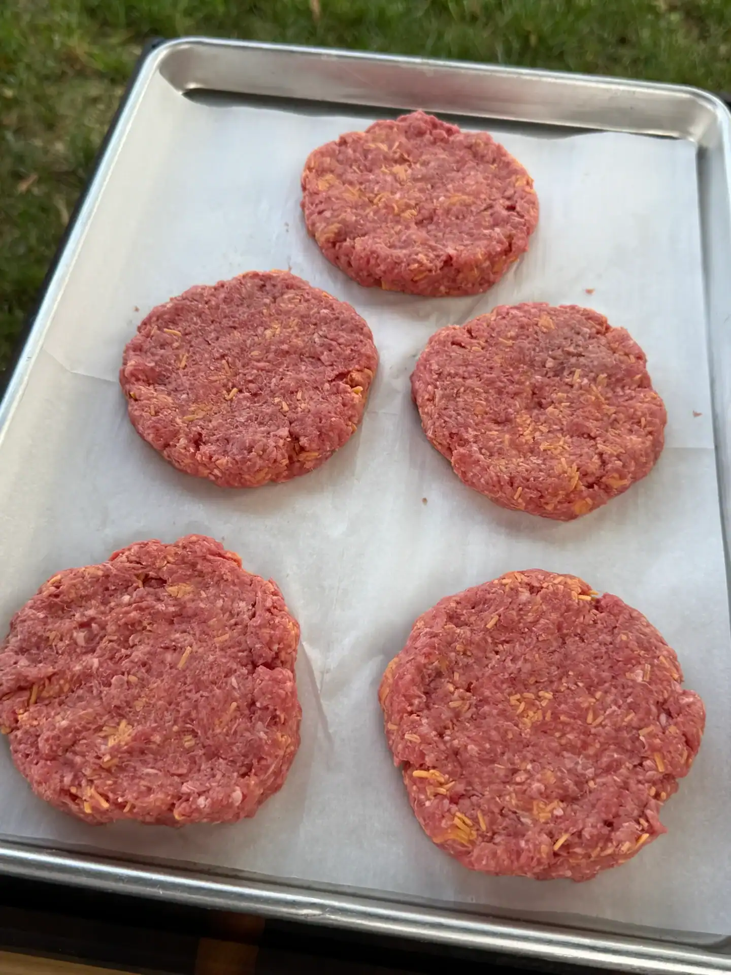 5 ground beef patties on a tray