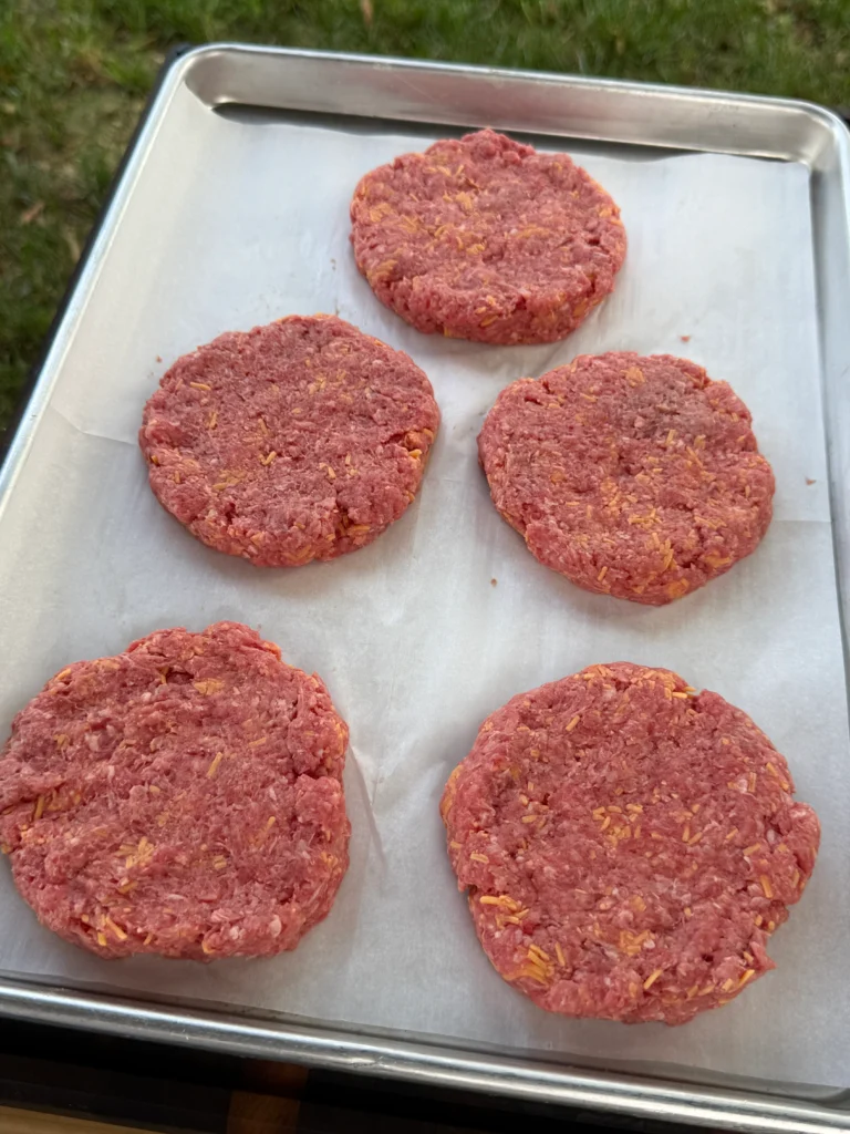 5 ground beef patties on a tray 