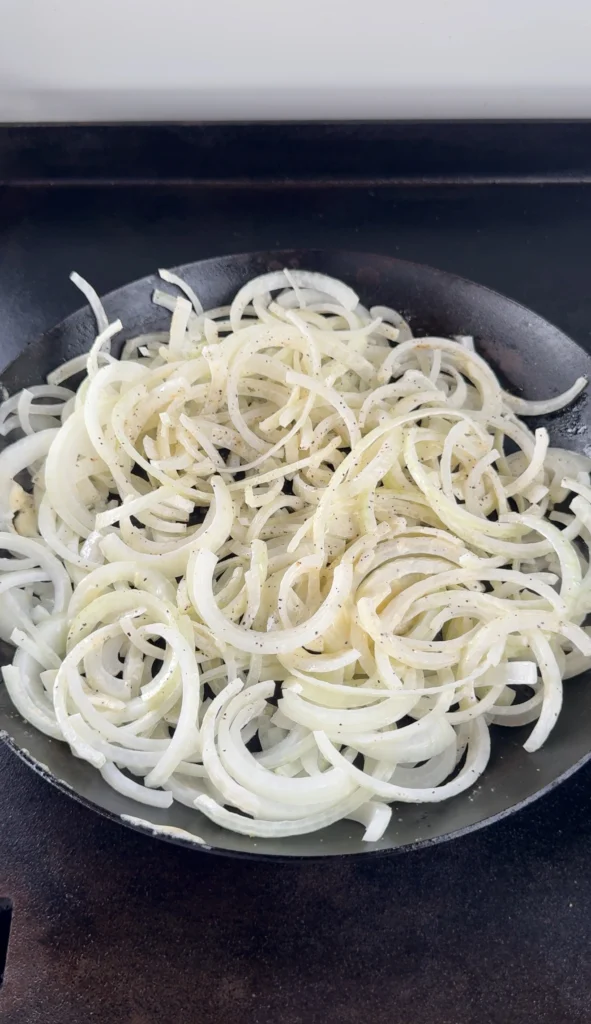 cut up onions in a pan to be cooked