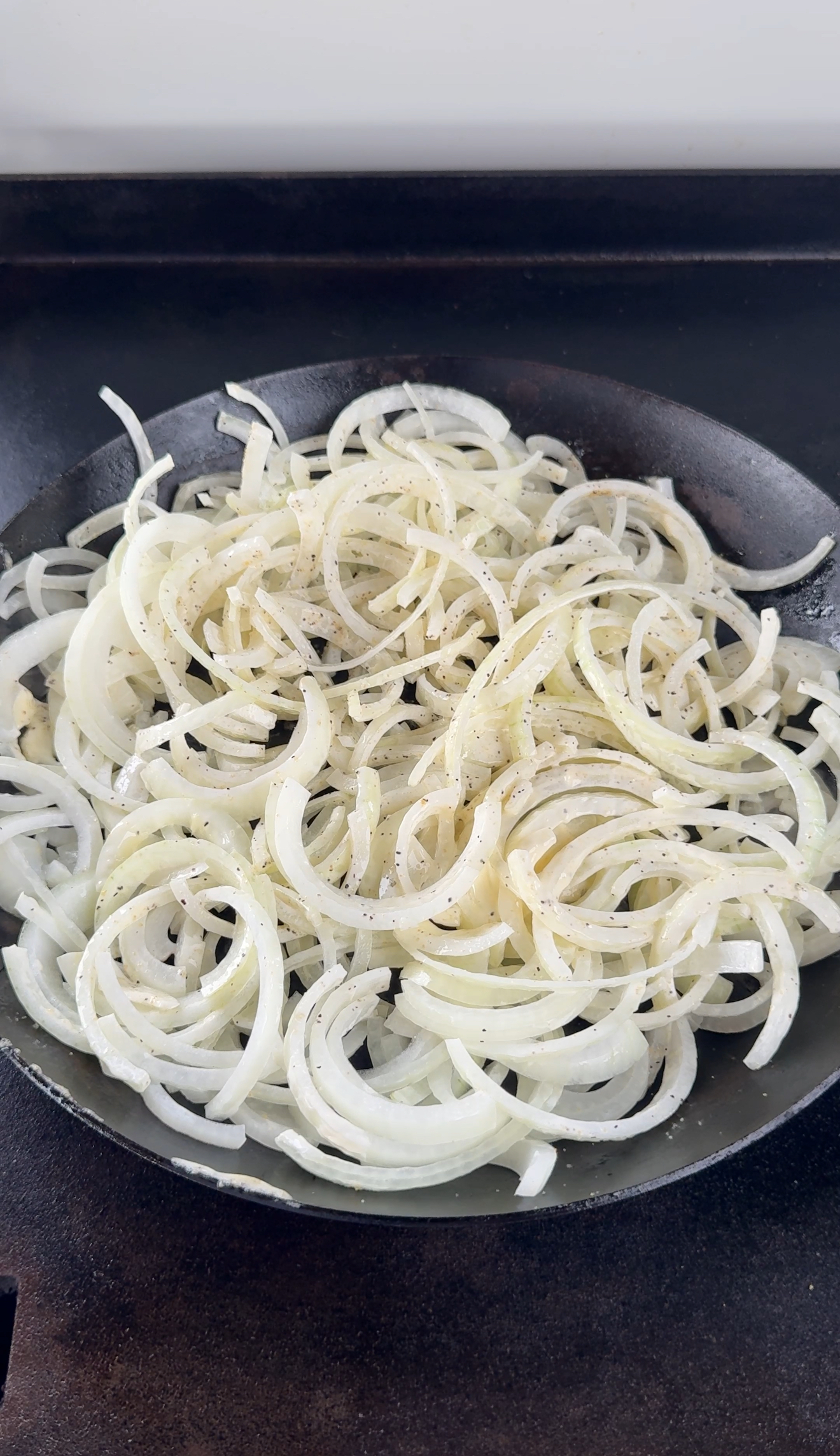 cut up onions in a pan to be cooked