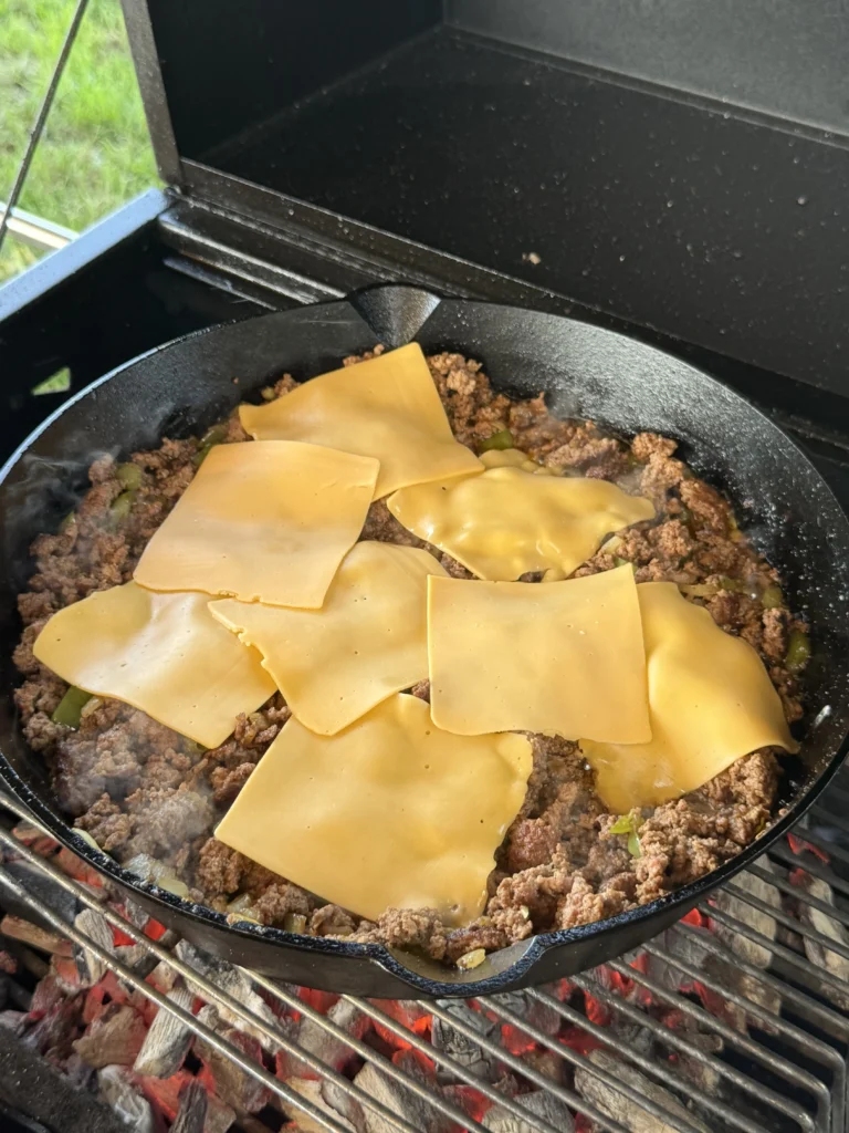chopped cheese in a cast iron skillet