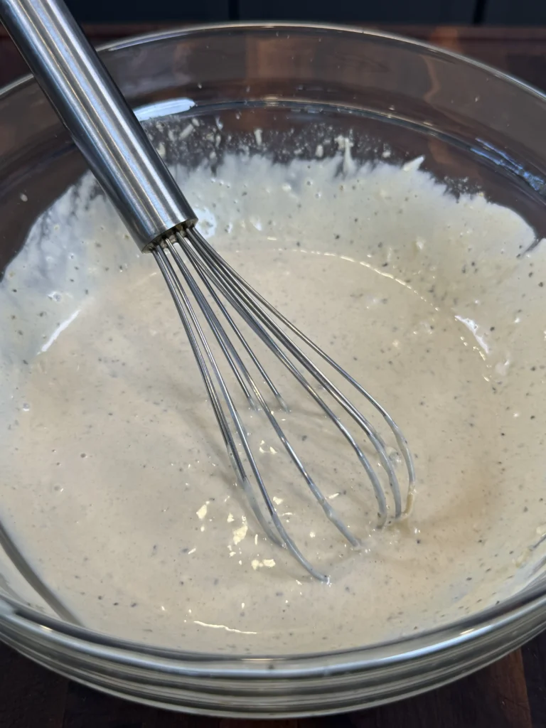 mixed caesar salad dressing in a bowl
