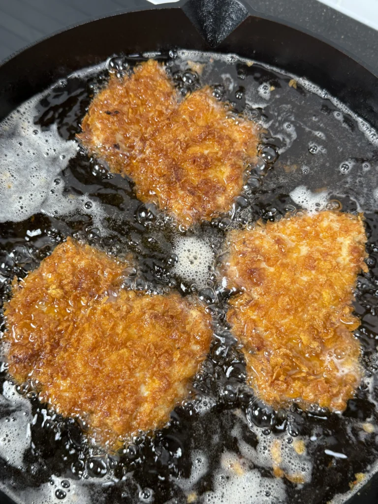 fried chicken thighs in the pan of oil