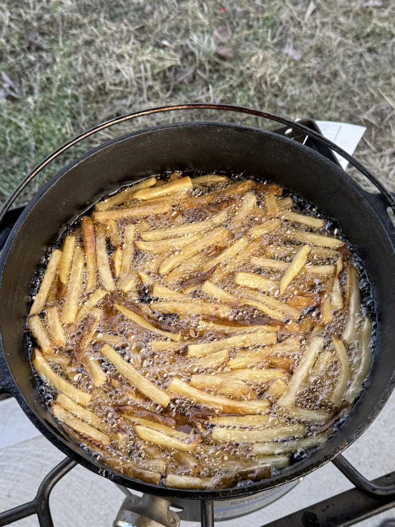 french fries being fried in a cast iron