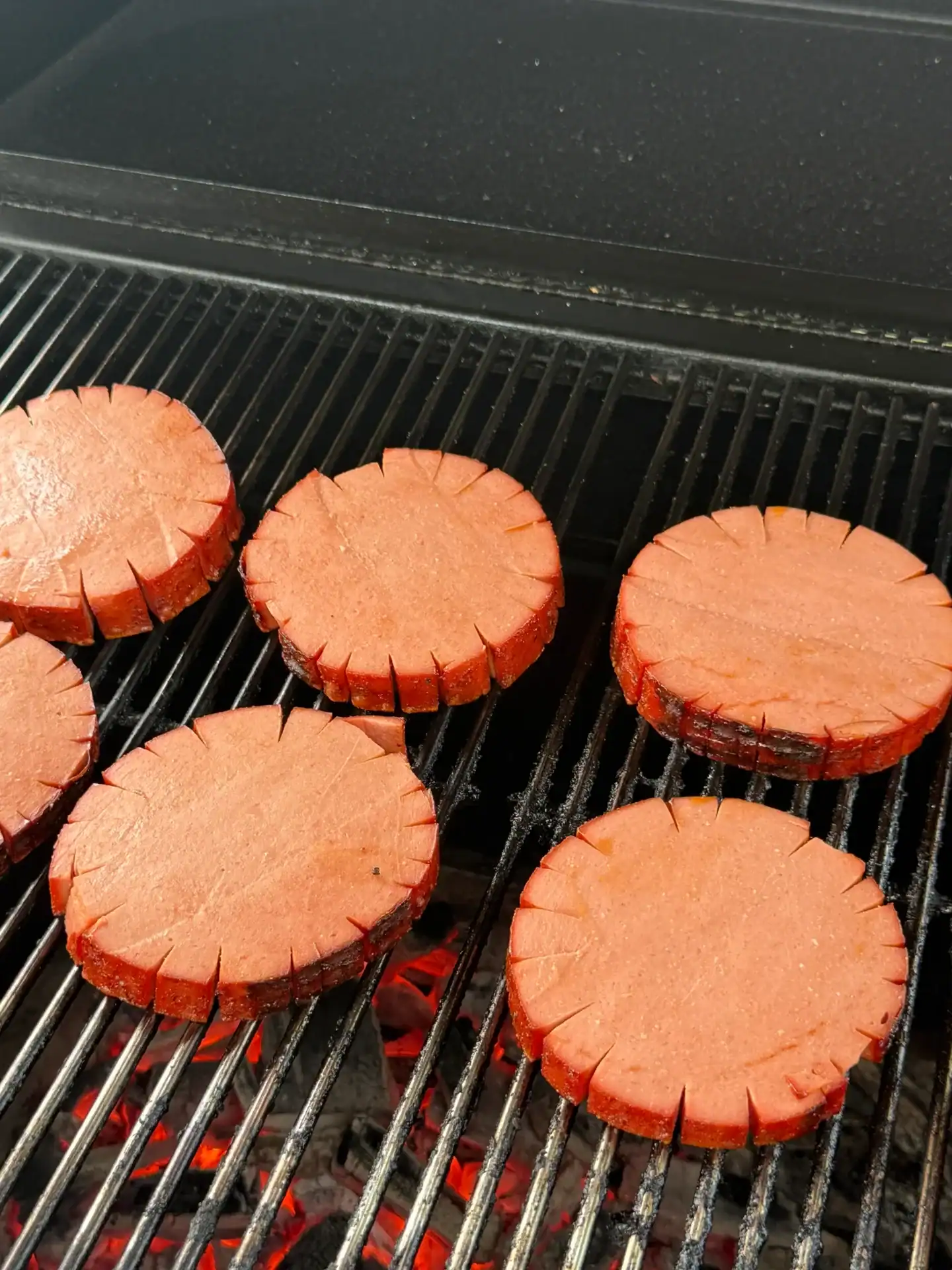 sliced smoked bologna on the grill