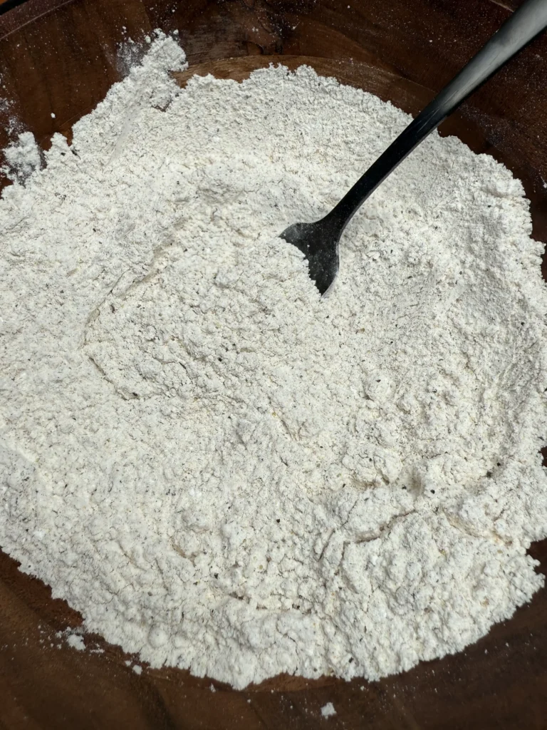 breading the chicken in a bowl