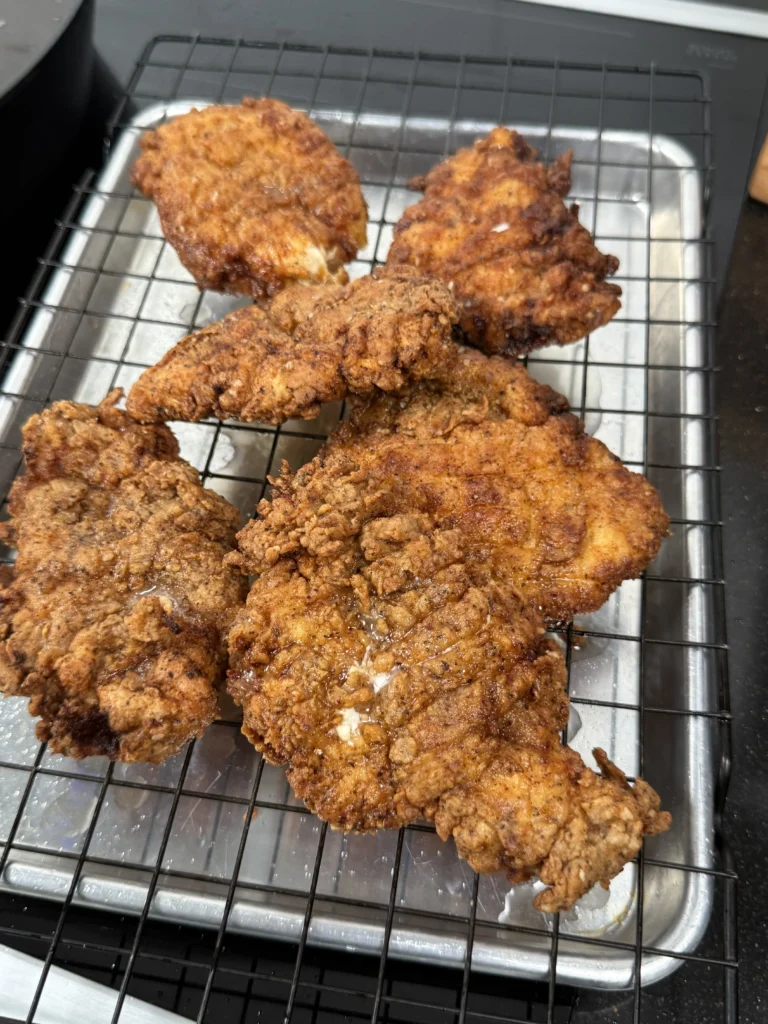 fried chicken resting on a rack