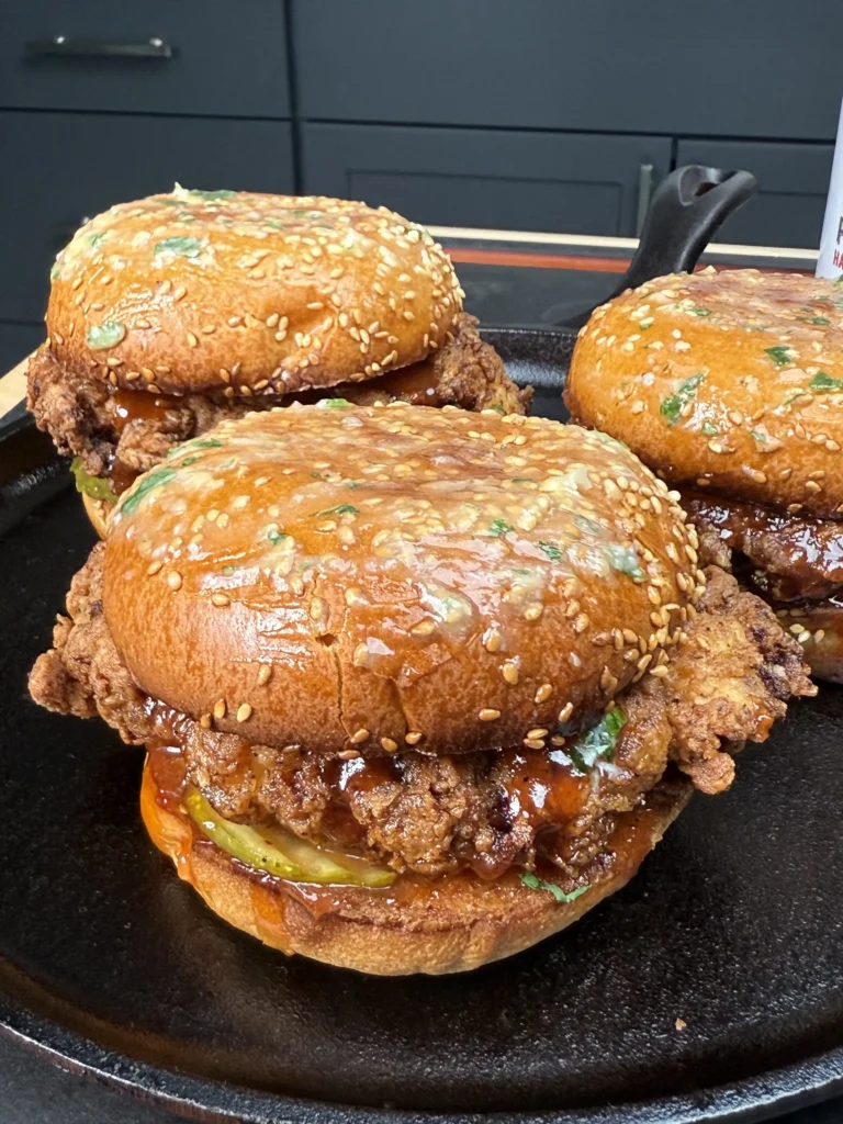 3 hawaiian chicken sandwiches on a cutting board