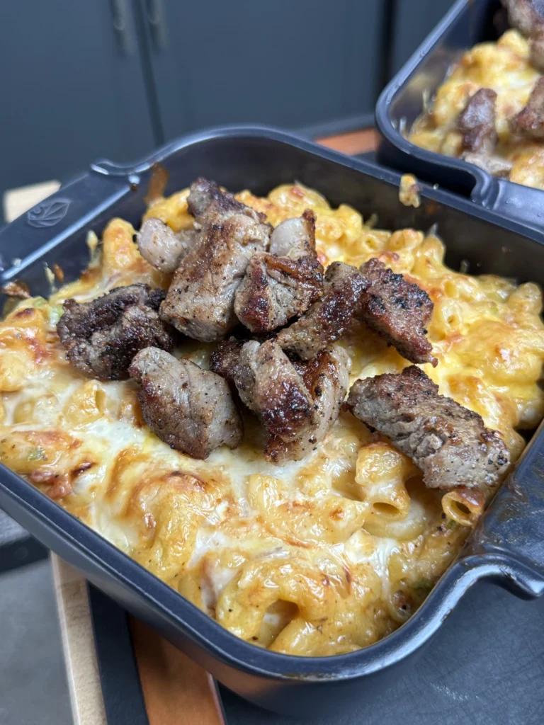 finalized loaded steak bites on the counter in a cast iron