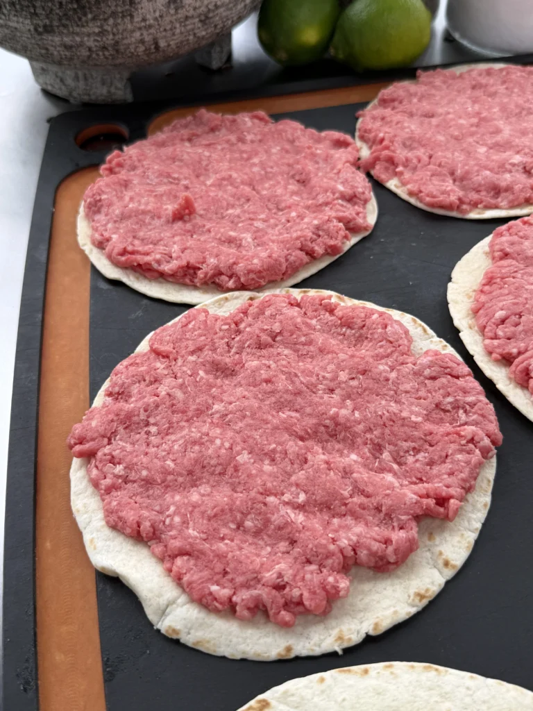 flattened ground beef on taco shells