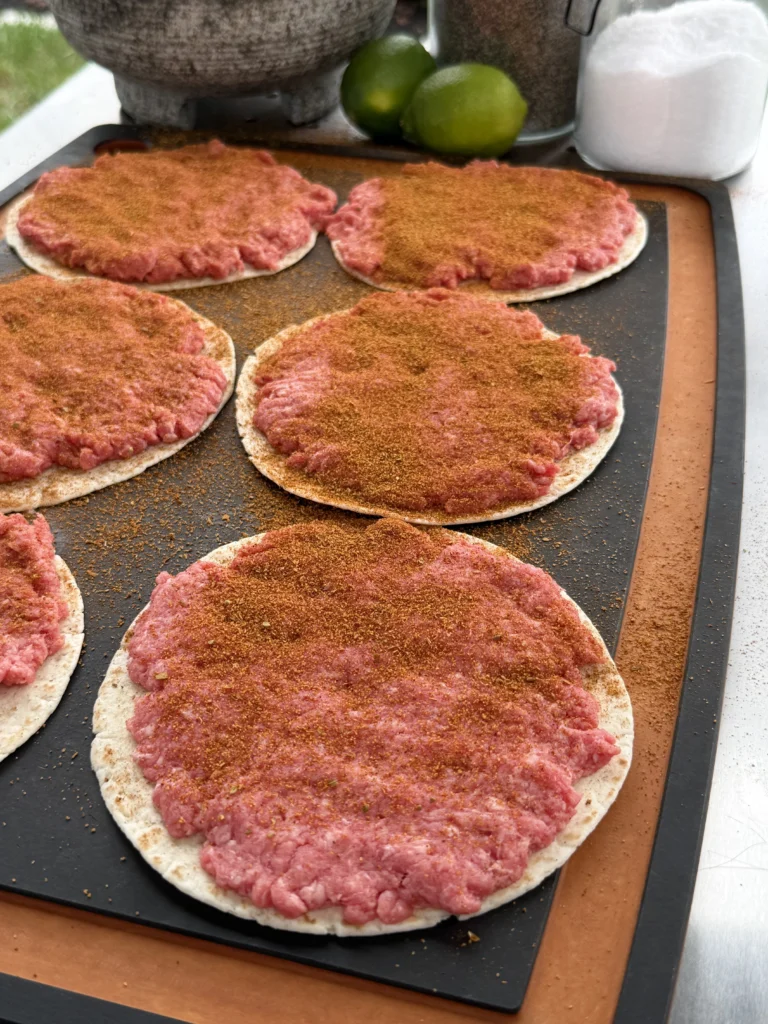 seasoned beef on the taco shells