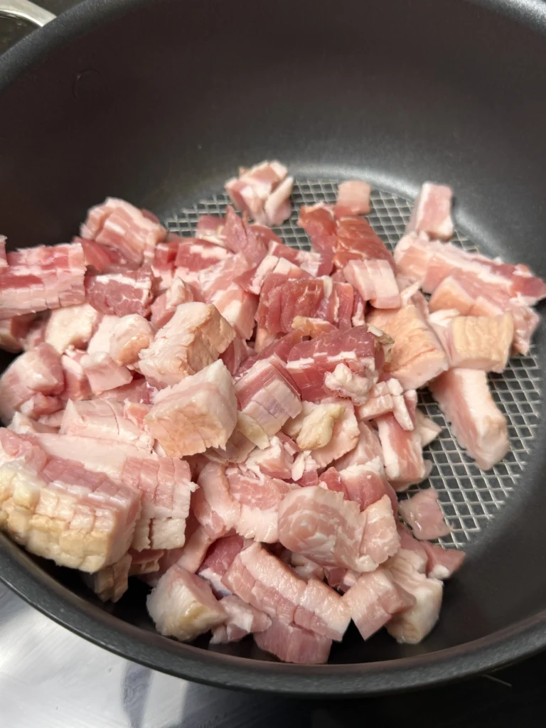 cooking the bacon in a pan