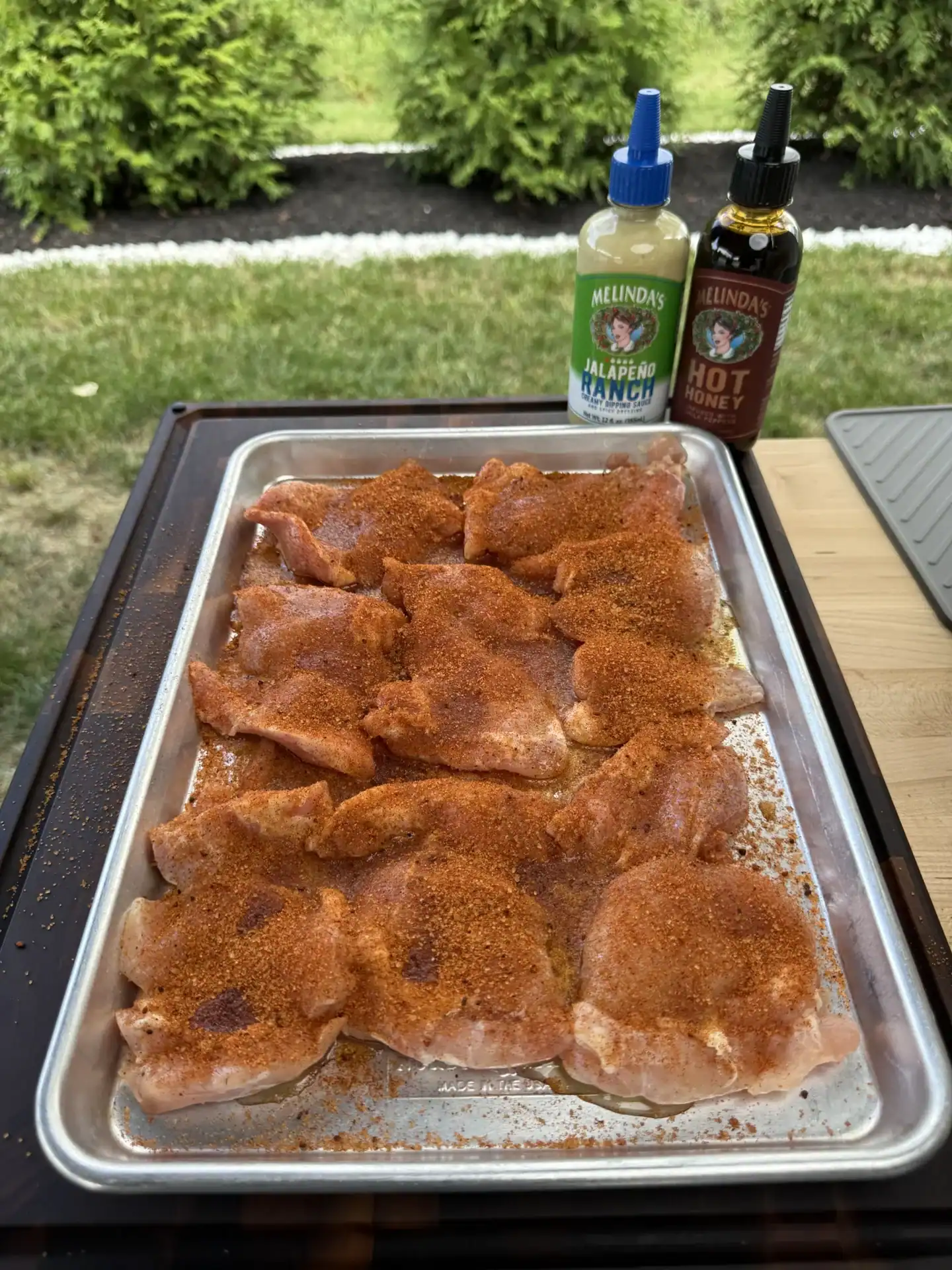 seasoned chicken thighs on the resting rack
