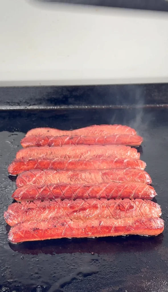 grilled hot dogs on a flat top