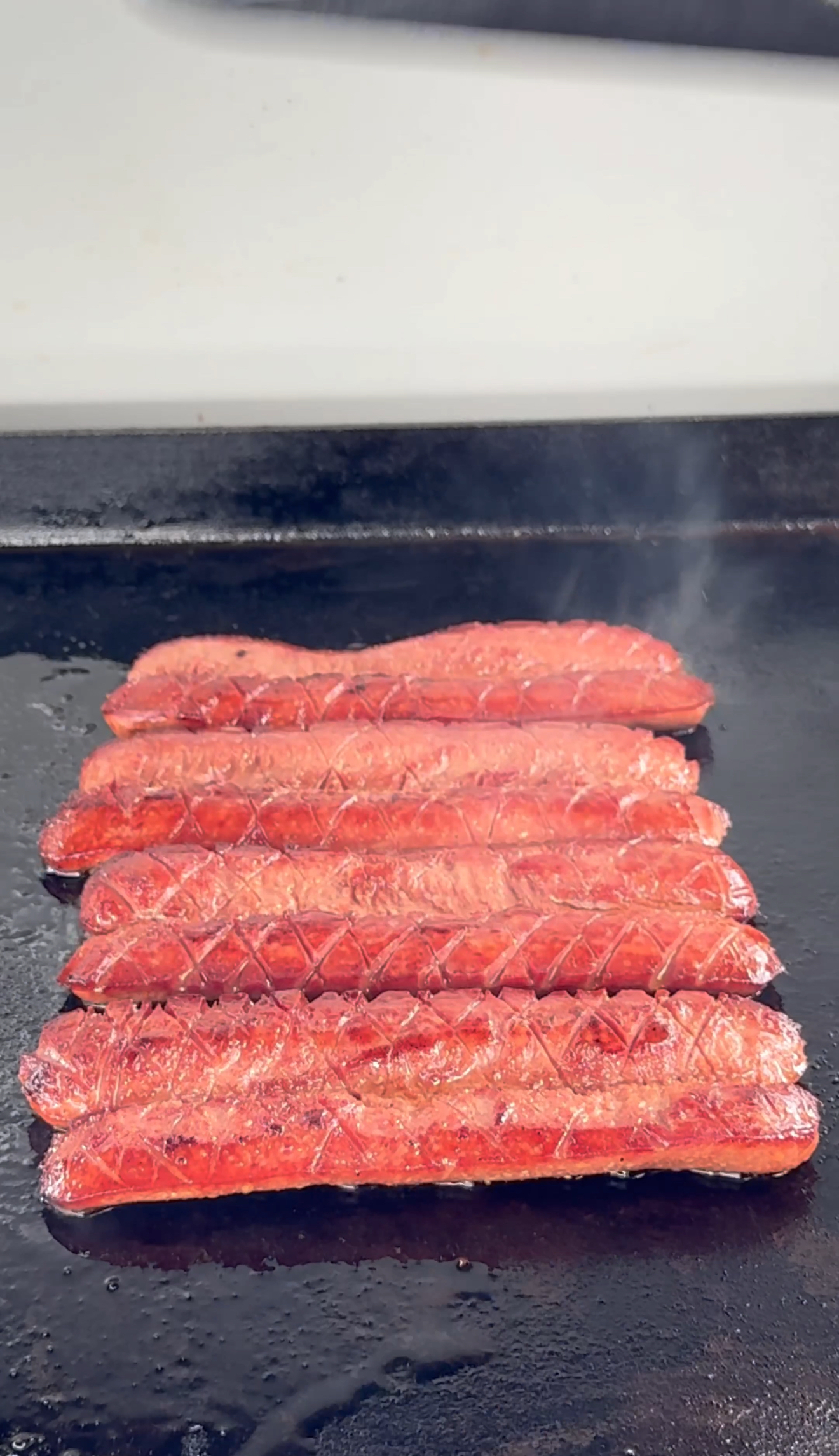 grilled hot dogs on a flat top