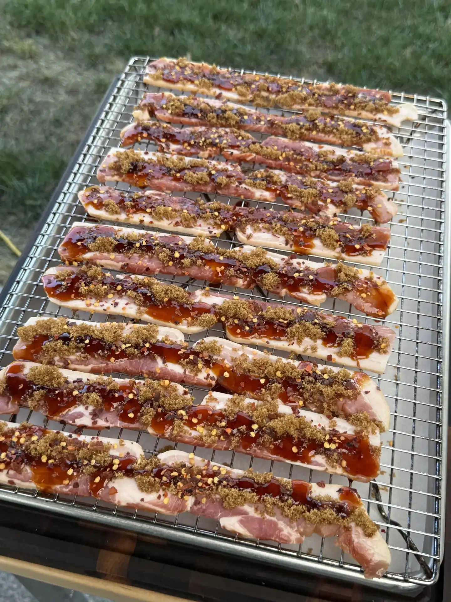 uncooked candied bacon on a rack