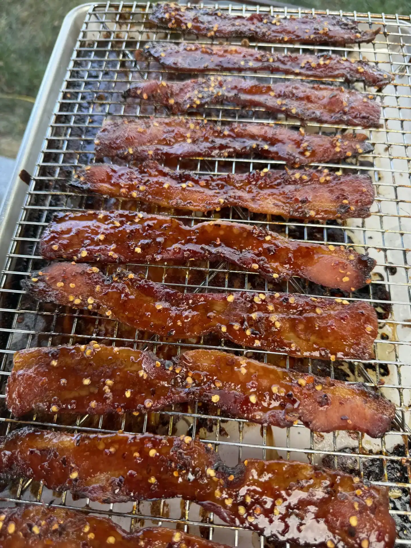 candied bacon strips on a resting rack