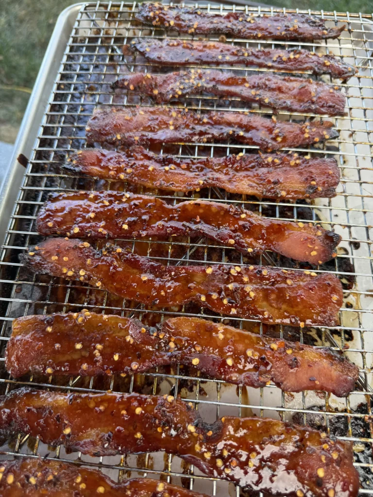candied bacon strips on a resting rack