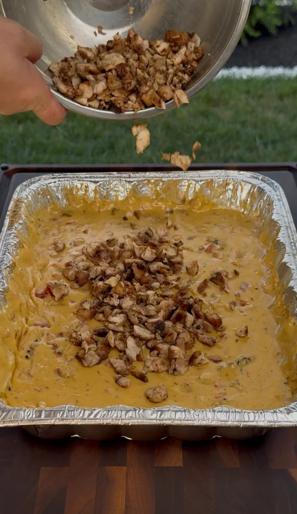 adding chicken to the queso
