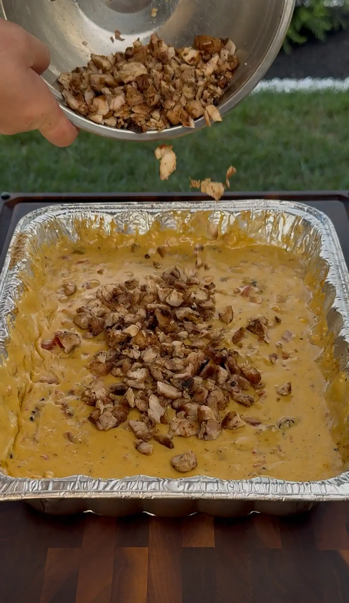 adding chicken to the queso