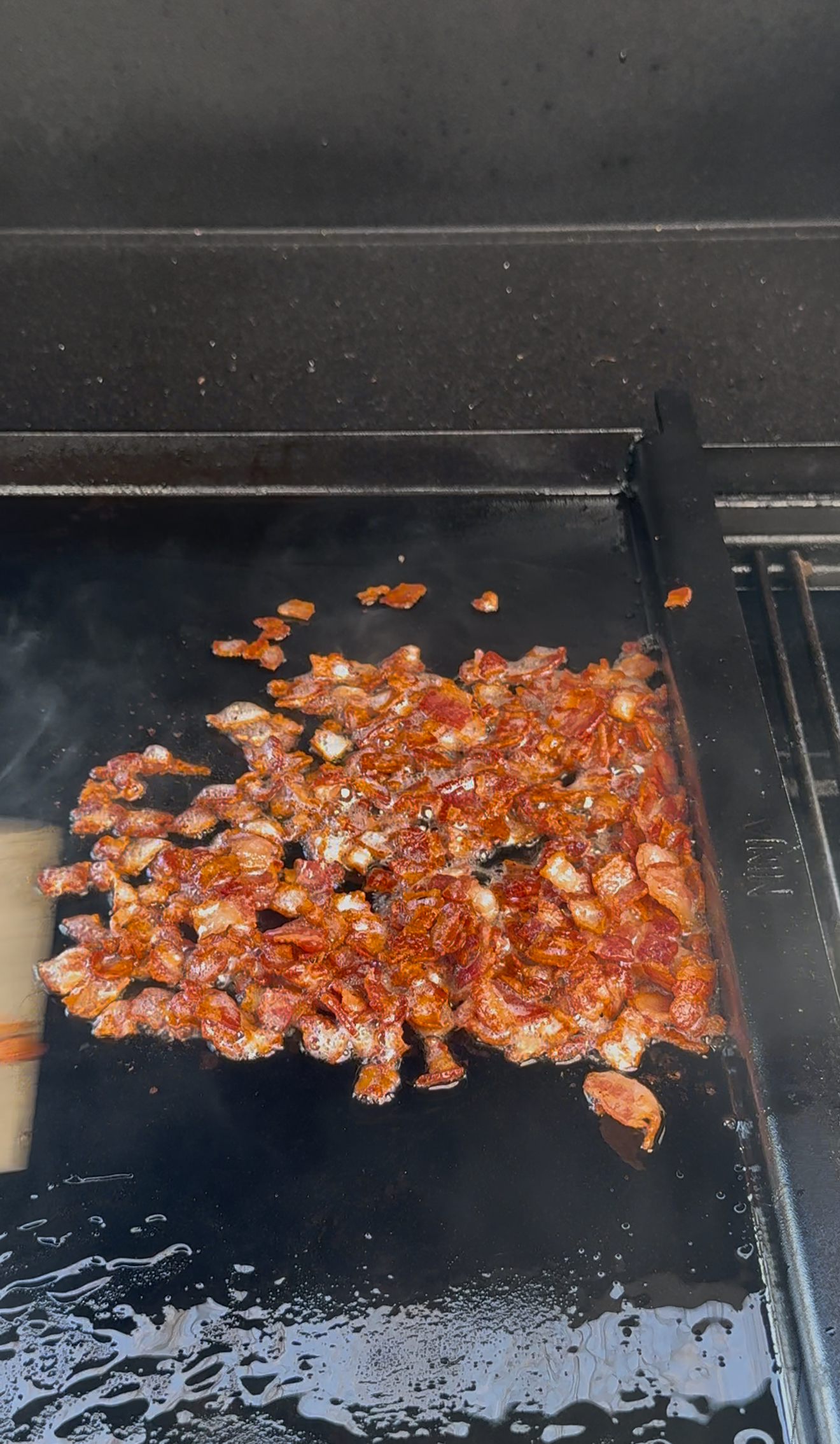 cooked bacon on the flat top