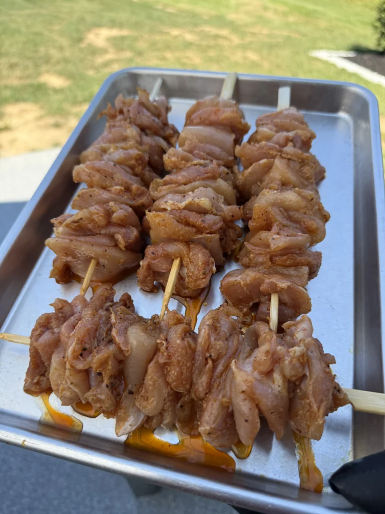 chicken skewers on the baking tray